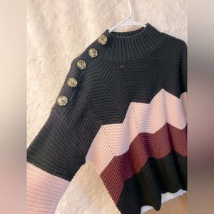 Adorable sweater with buttons on the side of the arm, very unique cozy look.